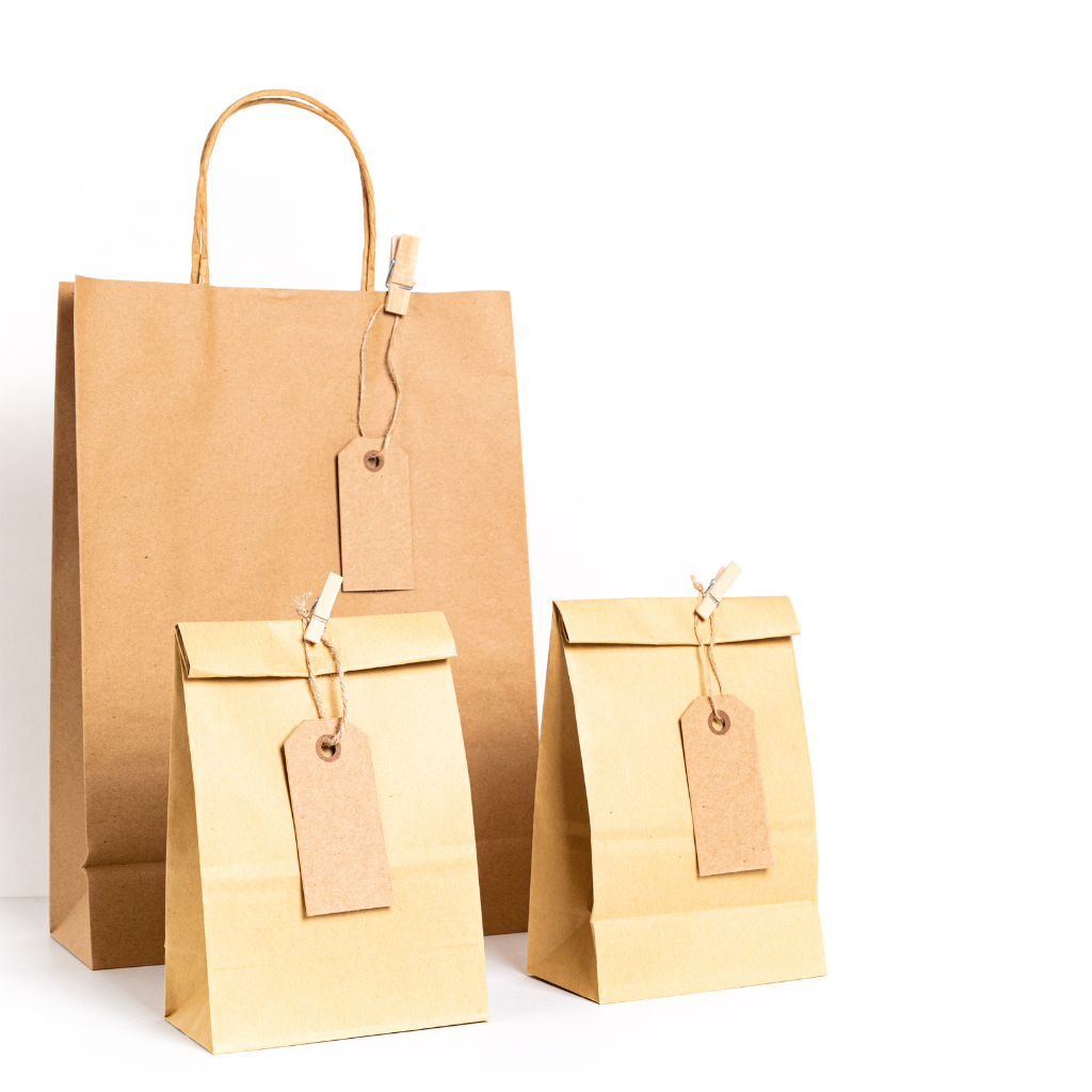 Various kraft paper products including envelopes, cups, and utensils
